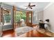 Cozy living room with wooden floors and double doors opening to a covered deck at 654 Cannon Rd, Sharpsburg, GA 30277