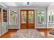 Cozy living room with wood floors and double doors offering backyard views at 654 Cannon Rd, Sharpsburg, GA 30277