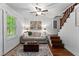 Comfortable living room with a ceiling fan and rustic decor, creating a warm and inviting space at 654 Cannon Rd, Sharpsburg, GA 30277