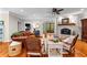 Charming living room with brick fireplace, hardwood floors, and views to office or front yard, a true sanctuary at 654 Cannon Rd, Sharpsburg, GA 30277