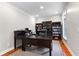 Home office boasts custom bookcases, ample workspace, and a comfortable executive chair, perfect for productivity at 654 Cannon Rd, Sharpsburg, GA 30277