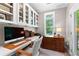 Bright home office with custom cabinets, built-in shelves, and a large window overlooking the greenery at 654 Cannon Rd, Sharpsburg, GA 30277