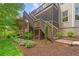 Exterior stairs leading to a deck, with manicured landscaping at 1315 Woodland Trce, Cumming, GA 30041