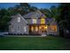 Charming two-story home featuring manicured lawn, inviting front porch, and elegant architectural details at 1315 Woodland Trce, Cumming, GA 30041