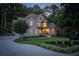 Charming home featuring a well-manicured lawn, inviting curb appeal, and mature trees at 1315 Woodland Trce, Cumming, GA 30041
