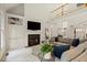 Cozy living room with built-in shelving, fireplace, and comfortable seating at 1315 Woodland Trce, Cumming, GA 30041