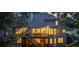 Rear of house at twilight, showing deck, stairs, and illuminated windows at 1315 Woodland Trce, Cumming, GA 30041