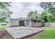 A large backyard features a stone patio and detached carport at 1982 Yucca Dr, Decatur, GA 30032