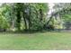 A spacious backyard featuring lush green grass and mature trees at 1982 Yucca Dr, Decatur, GA 30032