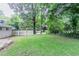 Large grassy backyard surrounded by trees for privacy at 1982 Yucca Dr, Decatur, GA 30032