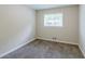 Cozy bedroom with neutral carpet, window, and fresh paint providing a serene atmosphere at 1982 Yucca Dr, Decatur, GA 30032