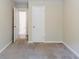 Bright bedroom showcasing a large closet and doorway that leads to a bathroom with neutral carpet at 1982 Yucca Dr, Decatur, GA 30032