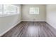 Empty room with hardwood floors, neutral walls, and natural light from the windows at 1982 Yucca Dr, Decatur, GA 30032