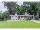 Charming one-story home featuring a red front door, brick accents, and a lush green lawn at 1982 Yucca Dr, Decatur, GA 30032