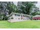A charming single-story home with well-maintained lawn and brick foundation, and carport at 1982 Yucca Dr, Decatur, GA 30032