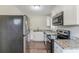 Renovated kitchen featuring stainless steel appliances, granite countertops, and ample cabinet space at 1982 Yucca Dr, Decatur, GA 30032