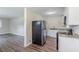 Open-concept kitchen with stainless steel refrigerator and updated cabinets, flowing into the living area at 1982 Yucca Dr, Decatur, GA 30032