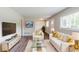 Bright living room with hardwood floors, white furniture, and a large window at 1982 Yucca Dr, Decatur, GA 30032