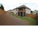 Spacious backyard features lush lawn and screened-in porch for outdoor enjoyment at 2311 Arnold Palmer Way, Duluth, GA 30096