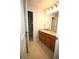 Bright bathroom featuring double sinks, granite countertops, tiled floors and an adjacent shower at 2311 Arnold Palmer Way, Duluth, GA 30096
