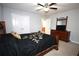 Cozy bedroom featuring carpet flooring, neutral walls, ceiling fan, and a double door closet at 2311 Arnold Palmer Way, Duluth, GA 30096
