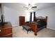 Bedroom featuring a bed and dresser with soft light from the covered window at 2311 Arnold Palmer Way, Duluth, GA 30096