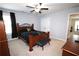 Charming bedroom featuring a wooden bed frame, carpet flooring, neutral walls, and large window at 2311 Arnold Palmer Way, Duluth, GA 30096