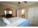Comfortable bedroom featuring neutral walls, blue floral bedding and a ceiling fan at 2311 Arnold Palmer Way, Duluth, GA 30096