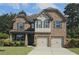 Charming two-story brick home with manicured landscaping and a two-car garage at 2311 Arnold Palmer Way, Duluth, GA 30096