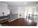 Bright hallway featuring hardwood floors, crown molding, and natural light from nearby windows at 2311 Arnold Palmer Way, Duluth, GA 30096