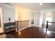 Well-lit hallway with hardwood floors and decorative console table, connecting to bedrooms and bathrooms at 2311 Arnold Palmer Way, Duluth, GA 30096