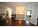 Hallway featuring hardwood floors, natural light, and views into other rooms at 2311 Arnold Palmer Way, Duluth, GA 30096