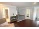 Well-lit hallway with hardwood floors and decorative console table, connecting to bedrooms and bathrooms at 2311 Arnold Palmer Way, Duluth, GA 30096