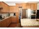A granite top island, stainless steel refrigerator and a built in microwave at 2311 Arnold Palmer Way, Duluth, GA 30096