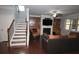 Comfortable living room featuring a fireplace, built-in shelving, and hardwood floors at 2311 Arnold Palmer Way, Duluth, GA 30096