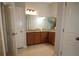 Bright bathroom featuring double vanity with wooden cabinets and granite countertop at 2311 Arnold Palmer Way, Duluth, GA 30096