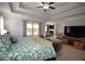 Spacious main bedroom with tray ceiling, ceiling fan, sitting area and large windows at 2311 Arnold Palmer Way, Duluth, GA 30096