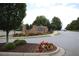 The front entrance sign for Berkeley Hills Estates features brick and beautiful landscaping at 2311 Arnold Palmer Way, Duluth, GA 30096