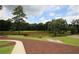 Community pond with a walking path and well maintained grounds and landscaping on a sunny day at 2311 Arnold Palmer Way, Duluth, GA 30096