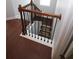 Staircase with wood and iron railing with hardwood floors leading to a lower level at 2311 Arnold Palmer Way, Duluth, GA 30096