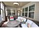 Bright screened-in porch with comfortable seating, decor, and an overhead fan at 2311 Arnold Palmer Way, Duluth, GA 30096
