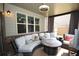Cozy screened-in porch with comfortable seating, stylish decor, and a ceiling fan at 2311 Arnold Palmer Way, Duluth, GA 30096