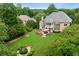 Aerial view of a large brick home featuring a beautiful green lawn and backyard at 2430 Flat Stone Dr, Cumming, GA 30041
