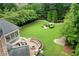 Expansive backyard with patio, manicured lawn, and landscaped garden at 2430 Flat Stone Dr, Cumming, GA 30041