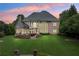 Sprawling backyard features patio, outdoor fireplace, screened in porch, and immaculate lawn at 2430 Flat Stone Dr, Cumming, GA 30041