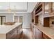 Stylish bar area with custom cabinetry, a stone countertop island, and modern pendant lighting at 2430 Flat Stone Dr, Cumming, GA 30041