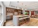 Basement bar with seating, shelving and cabinetry with a wine and beverage refrigerator at 2430 Flat Stone Dr, Cumming, GA 30041