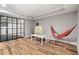 Finished basement features a game area, orange hammock, and full glass wall gym at 2430 Flat Stone Dr, Cumming, GA 30041