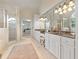 Elegant bathroom features double vanities, a walk-in shower, and neutral tile flooring at 2430 Flat Stone Dr, Cumming, GA 30041