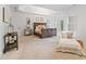 Spacious bedroom featuring a tray ceiling, elegant furnishings, and abundant natural light at 2430 Flat Stone Dr, Cumming, GA 30041